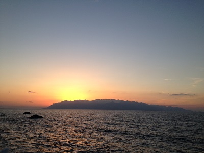 Sunset Behind Yakushima With Few Clouds And Bright Glow