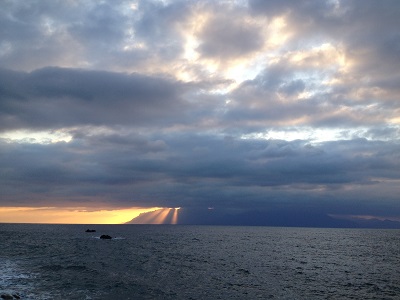 Sunset Behind Yakushima With Sun Rays Through Clouds