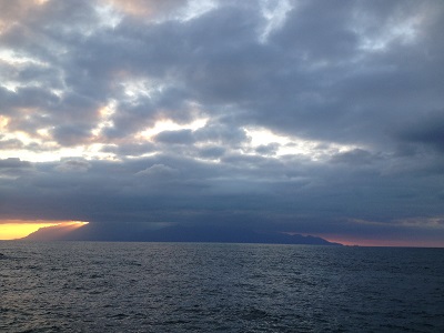 Sunset Behind Yakushima With Sun Rays Through Clouds