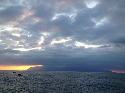 Sunset Behind Yakushima With Sun Rays Through Clouds